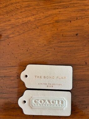 Coach Leatherware The Soho Flap Bag Tags in Cream colored leather Adjustable